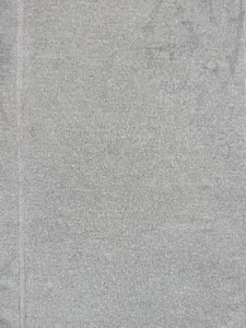 Macro view of grey knit fabric with vertical ribbing and flatlock stitching detail