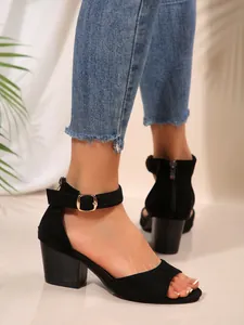 Detailansicht eleganter schwarzer Wildleder-Sandalen mit Blockabsatz und Schnalle