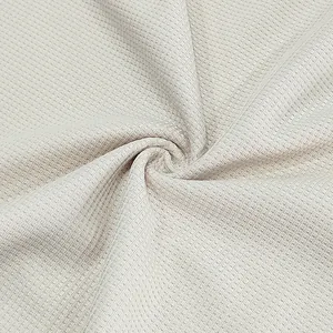 Close-up detail of breathable waffle knit fabric texture for men's summer polo set