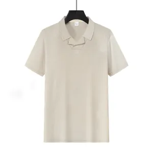 Detailed view of the breathable beige waffle knit fabric on this relaxed men's polo shirt