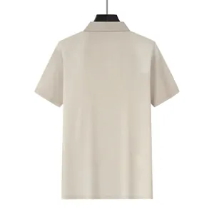 Detailed back view of a men's beige waffle knit polo shirt with short sleeves.