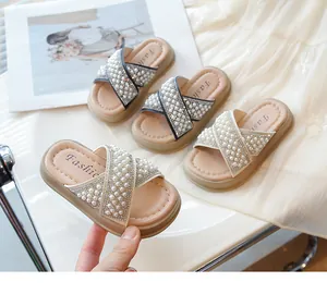 Vista detallada de sandalias de verano para niñas con perlas y pedrería en beige y negro