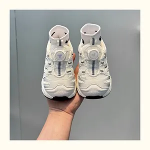 Detailed front view of kids breathable white chunky sneakers with easy rotating buckle system