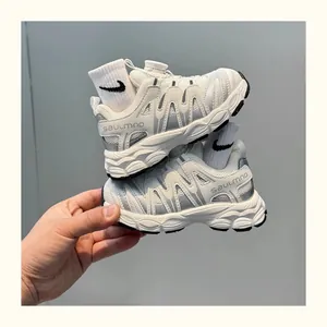 Close-up of children's breathable white sports shoes with rotating buckle and mesh details