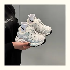 Close-up detail of white kids' breathable sneakers with a convenient rotating buckle system