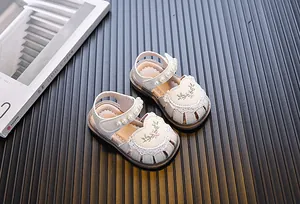 Detailed view of baby girl princess sandals featuring elegant pearl and flower embroidery