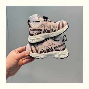Detail view of pink children's sneakers with breathable mesh and rotary buckle closure