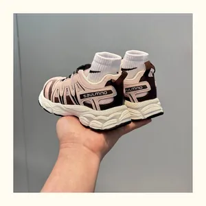 Close-up of pink and brown children's breathable dad shoes with thick white soles