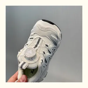 Close-up of breathable kids' sneakers with a modern rotating buckle lacing system.