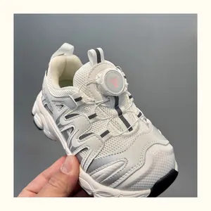 Macro view of breathable kids white sneakers featuring innovative rotating buckle