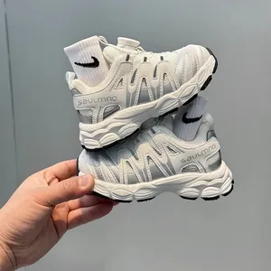 Breathable children's sports sneakers with rotating buckle closure in white and grey