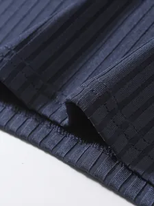 Detailed macro shot showing high-quality ribbed fabric texture and professional hem stitching.