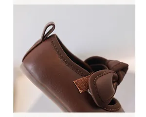 Close-up detail of soft brown leather and stitching on baby princess walking shoes
