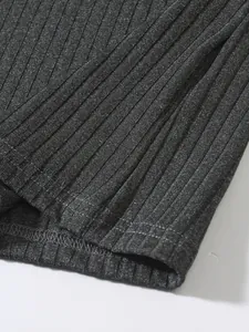 Detailed view of the charcoal grey ribbed knit texture and hem stitching on this men's vest