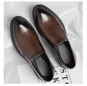 Close-up of dark brown men's business leather shoes with crocodile embossed pattern.