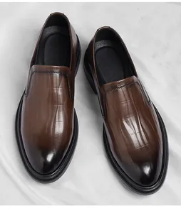 Professional macro shot of brown crocodile texture men's slip-on formal business shoes