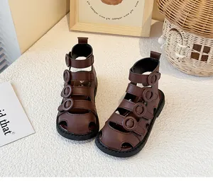 Detail view of brown toddler Roman sandals with high-top and multi-strap buckles
