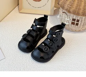 Detailed view of black closed-toe Roman sandals for toddlers with soft non-slip soles.