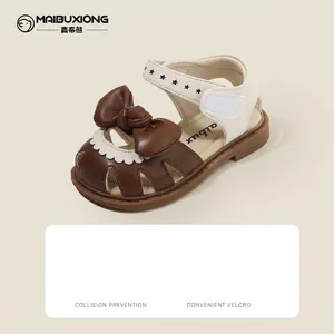 Stylish baby girl closed-toe sandals with decorative bow and velcro closure strap