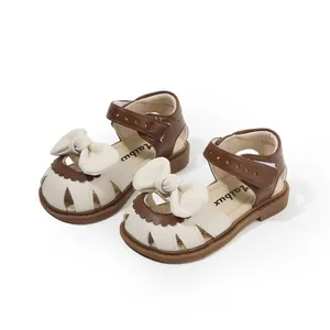 Toddler girl's closed-toe summer sandals with bow decoration in beige and brown colors
