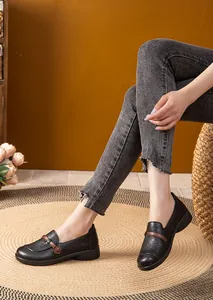 Elegant black laser-cut leather loafers for women with comfortable low heel