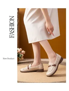 Beige breathable loafers for elderly women featuring intricate cut-out floral patterns.