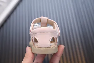 Detailed back view of pink toddler girl walking sandals featuring soft rubber sole