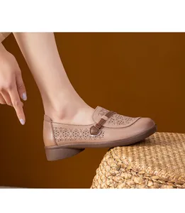 Detail of breathable hollow-out loafers with soft sole for women in khaki brown finish.