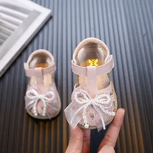 Lovely pink princess baby sandals featuring pearl bow and soft sole for toddlers