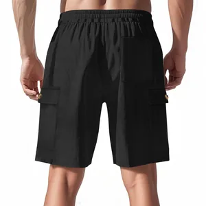 Detail view of black corduroy cargo shorts showing back pockets and fabric texture.