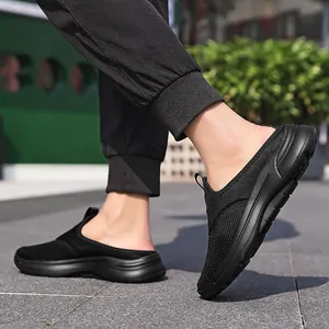 Dynamic close-up view of a man walking in black mesh slip-on casual shoes outdoors