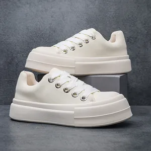 Side view of white chunky platform sneakers with thick soles and casual bread shoe design