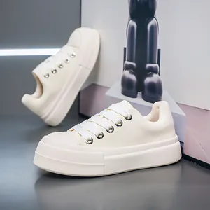 Cream-colored men's thick-soled chunky sneakers in a professional studio setting.