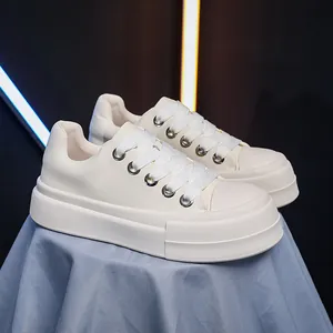 Side view of cream white platform bread shoes with thick sole and wide white laces.