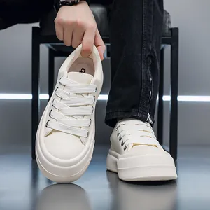 Close-up of men's beige chunky platform sneakers showing thick sole detail.