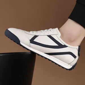 Men's vintage white leather German Army Trainer sneakers with navy blue accents side view