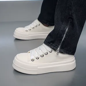 Detailed view of men's chunky cream white sneakers with a thick platform sole design.