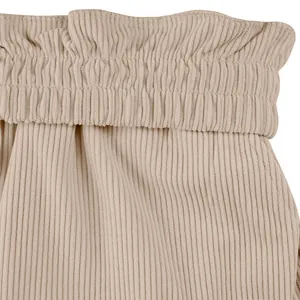 Macro view of the elastic pleated waistband on these beige corduroy cargo shorts.