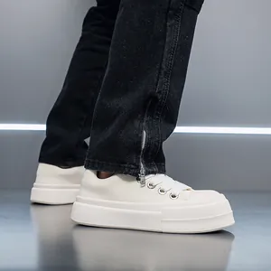 Detailed side view of men's stylish cream chunky platform sneakers with thick soles