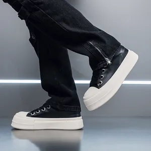 Detailed side view of men's black and white chunky platform sneakers worn with jeans