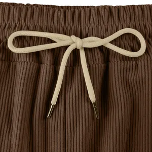 Detailed macro view of the beige drawstring and brown corduroy fabric on men's shorts