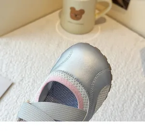 Close-up of silver mesh sneakers for girls showing premium material texture.