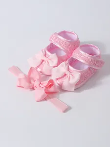 Detailansicht der rosa Prinzessinnenschuhe für Babys mit Spitze und Satinschleifen
