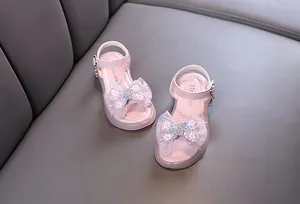 Pink girls' princess sandals with sparkly floral bows, perfect for summer performance