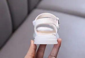 Detailed rear view of white girls' princess sandals with soft non-slip rubber soles
