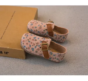 Close-up of pink floral girls' Mary Jane shoes with brown leather buckle strap