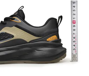 Close-up showing the 5cm thick sole height of black breathable sneakers with a measuring ruler