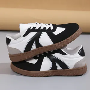 Close-up side view of black and white retro GAT sneakers with durable gum soles
