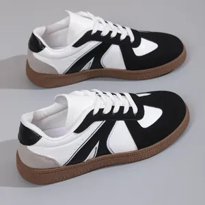 Detailed view of retro German Army Trainer sneakers in black and white leather