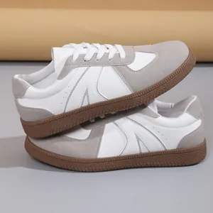 Side view of retro white and grey GAT sneakers featuring premium textured leather details